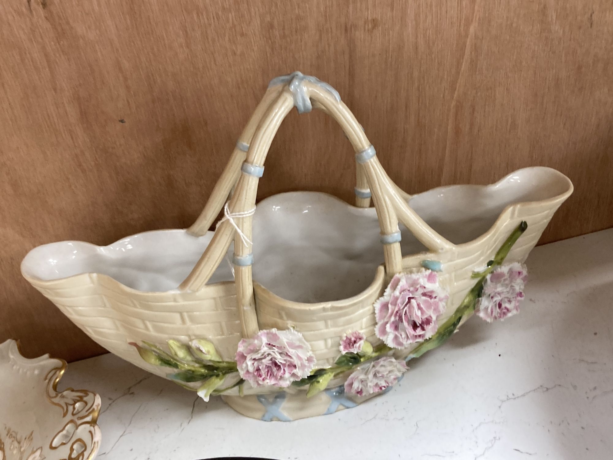A Continental porcelain shaped oval posy basket encrusted with carnations and sundry ceramics,